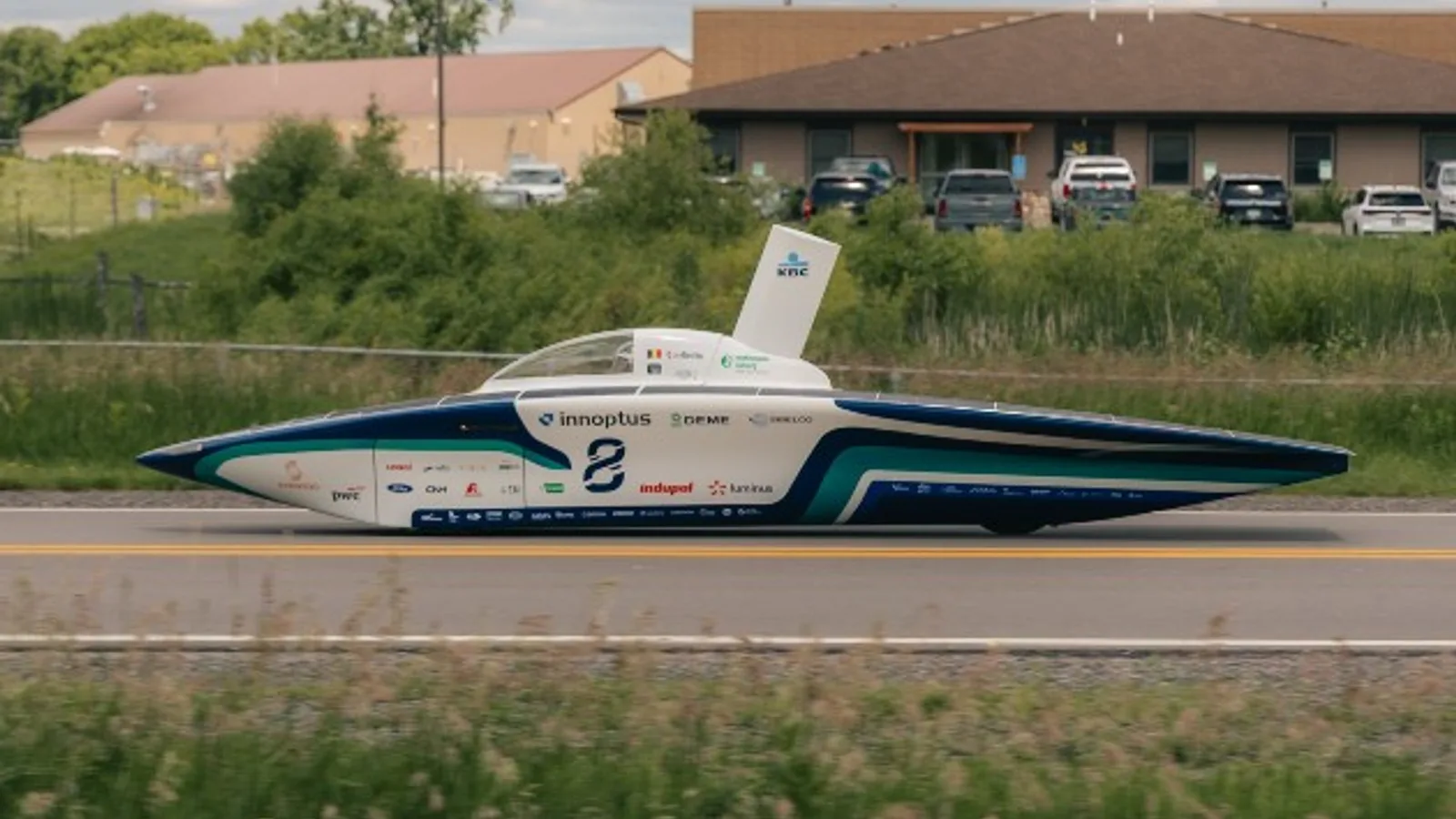 solar racing car and team preparing for race